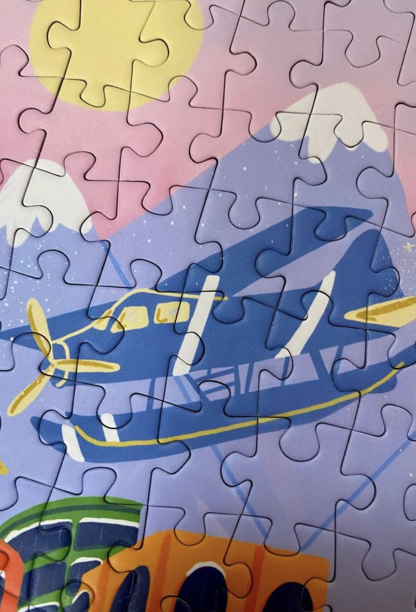 Olleo Vancouver puzzle close-up of a blue seaplane over snowy mountains